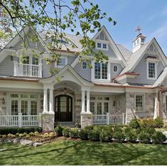 a large gray house with white trim and windows