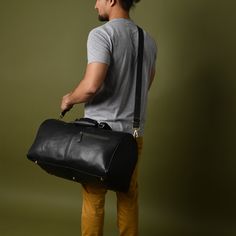 GUARANTEED CHRISTMAS DELIVERY ON ORDERS PLACED BEFORE THE 19TH OF DEC. This leather duffel bag seamlessly blends timeless elegance with durable functionality, making it the perfect companion for every occasion. Whether it's a quick getaway, a stylish weekend trip, or a visit to the gym, this versatile carry-on bag will go with you anywhere. Crafted from soft full-grain leather, reliable YKK Zipper and rust free antique brass fittings and studs, it exudes sophistication. With its optimal size, abundance of pockets, lightweight and flexible design, and a removable shoulder strap, this bag is an ideal choice for all your travel needs. DIMENSIONS-  Length: 51 cm/ 20 inches  Height: 28cm / 11 inches Depth:  28cm / 11 inches ► DELIVERY: Same Day Shipping.Free Express Delivery in 4-6 working days Modern Everyday Duffle Bag With Leather Backing, Black Soft Leather Duffle Bag, Black Leather Functional Duffle Bag, Black Duffle Bag With Leather Lining For Daily Use, Functional Black Leather Duffle Bag, Black Leather Rectangular Duffle Bag, Modern Duffle Bag With Leather Backing, Black Leather Gym Bag, Black Leather Rectangular Gym Bag