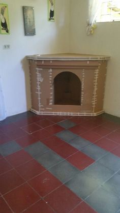 a dog house built into the side of a wall in a room with tile flooring