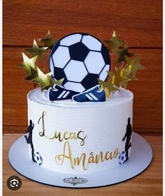 a soccer themed birthday cake with stars and a soccer ball on top that says lucas amancas