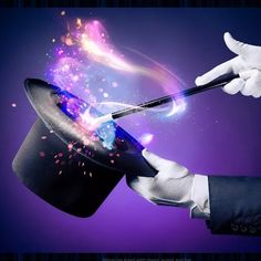 a magician's hand holding a magic wand over a top hat with fireworks coming out of it