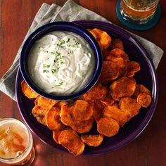 a blue plate topped with potato chips and dip