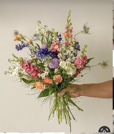 two pictures one with flowers and the other has an image of someone holding it in their hand