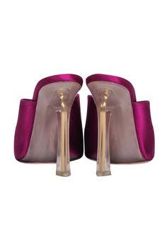 Step out in head-turning style with these Nina Ricci magenta pink satin mule pumps. The open toe heel showcases a clear heel design for a light and airy look, perfect for any date night. Make a statement and show off your fashion-savvy with these eye-catching and chic mules! Size 7.5 Satin fabric upper Clear acrylic heel Pointed toe Heel height 4" Party Heels With Sculpted Heel And Slip-on Design, Pink Mules With Sculpted Heel For Party, Pink Open Toe Mules For Party, Pink Evening Mules With Padded Heel, Pink Slip-on Sandals For Evening, Elegant Pink Mules With Sculpted Heel, Elegant Pink Evening Mules, Pink Mules With Padded Open Heel, Pink High Heel Mules For Formal Occasions