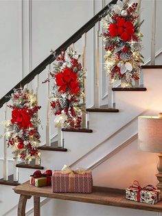 christmas decorations on the banisters and stairs in a house with presents under them