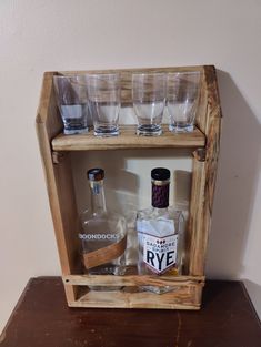 a wooden shelf filled with glasses and bottles