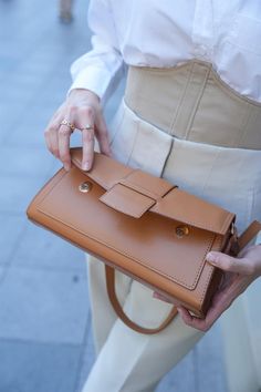 Add a touch of warmth and sophistication to your ensemble with the "Caramel Rectangular Bag" from Lunarity Garage. This chic and stylish accessory features a sleek rectangular design in a rich caramel color, making it a versatile addition to your wardrobe. The caramel hue exudes a sense of timeless elegance and pairs beautifully with a variety of outfits. Crafted with meticulous attention to detail, this bag offers both fashion and functionality. The compact size is perfect for carrying your ess Trendy Brown Baguette Bag For Office, Brown Satchel Baguette Bag For Office, Brown Baguette Bag With Detachable Strap For Everyday, Everyday Brown Baguette Bag With Detachable Strap, Brown Rectangular Clutch For Everyday Use, Brown Baguette Bag With Adjustable Strap For Office, Rectangular Shoulder Bag For Fall, Chic Light Brown Satchel For Everyday Use, Fall Rectangular Solid Color Shoulder Bag