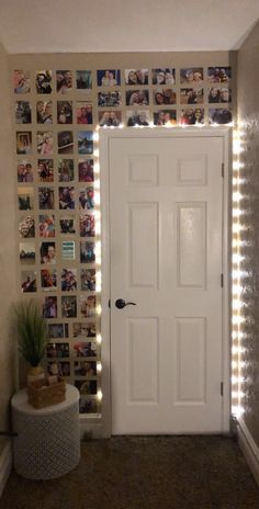 a white door sitting next to a wall with pictures on the wall and lights behind it