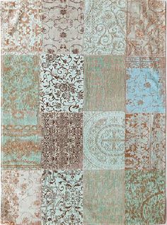 a patchwork rug with various colors and patterns on it, including blue, green, brown