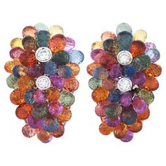 This pair of Graff earrings features briolette sapphires in multiple hues of blue, green, yellow, orange and pink. As well as approximately 2.50 carats of round brilliant cut diamonds with F-G color and VS clarity. They measure approximately 30mm x 19mm. Signed "Graff No.15". Graff Earrings, Graff Jewelry, Graff Diamonds, Diamond Chandelier Earrings, Cocktail Earrings, Jaune Orange, Hues Of Blue, Purple Sapphire, Cute Flowers