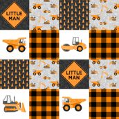 a patchwork quilt with construction vehicles and little man on the front in orange, black and white