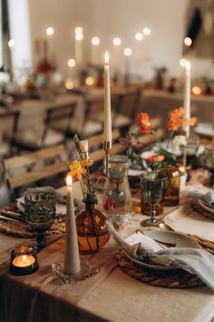 the table is set with candles and dishes