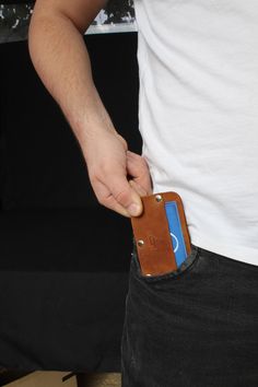 This handmade minimalist leather wallet is crafted from premium genuine leather and designed for those who value style and practicality. Its slim, compact design fits effortlessly in any pocket, making it perfect for carrying cards and cash without unnecessary bulk. With RFID-blocking technology, your information is secure from digital theft, while the durable metal rivets ensure long-lasting use. Whether you're looking for a stylish everyday wallet or a thoughtful gift, this bifold leather wallet offers the perfect combination of durability, function, and minimalist appeal. Suitable for both men and women, it ages beautifully, developing a unique patina over time. Modern Compact Trifold Wallet With Coin Pocket, Minimalist Leather Trifold Wallet Gift, Modern Compact Leather Trifold Wallet, Compact Leather Wallet With Coin Pocket, Mens Leather Wallet Bifold, Minimalist Leather Wallet, Slim Leather Wallet, Leather Wall, Genuine Leather Wallets