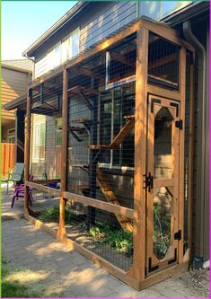 an outdoor chicken coop made out of wood and wire