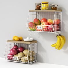 two metal baskets filled with fruit on top of a white counter next to each other