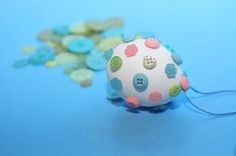 a white ball with multicolored polka dots on it sitting next to some buttons