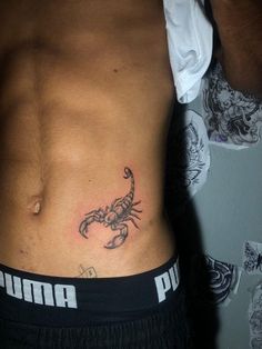 a man with a scorpion tattoo on his stomach