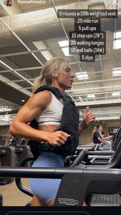 a woman is running on a treadmill in the middle of an exercise room with her back to the camera