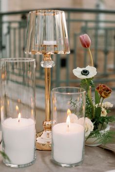 candles and flowers are sitting on a table