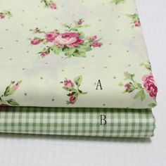 three pieces of fabric with pink roses on white and green checkered sheets, one is folded