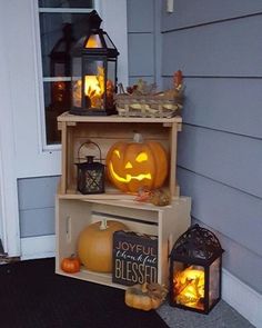 two shelves with pumpkins and lanterns on them