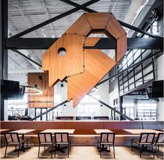 the interior of a restaurant with wooden tables and chairs