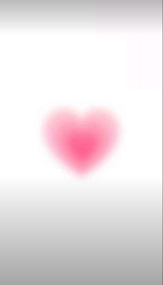 a heart shaped object is shown in the middle of a blurry image with white background