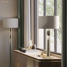 a table with a lamp and some books on it next to a window sill