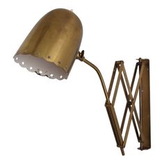 an antique brass desk lamp on a white background