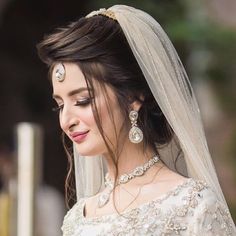 a woman in a wedding dress and veil