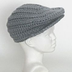 a white mannequin head wearing a gray knitted hat