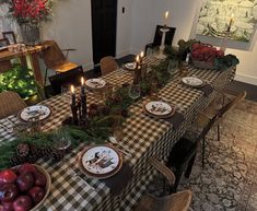 the table is set with plates and candles