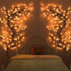 a bed with lights on the headboard and wall behind it