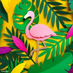 a pink flamingo standing on top of a lush green leaf covered field next to leaves