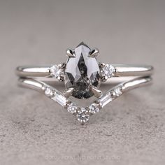 a white gold engagement ring with an oval cut diamond surrounded by baguette diamonds