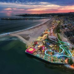 an aerial view of the beach and amusement park at sunset or sunrise, from above