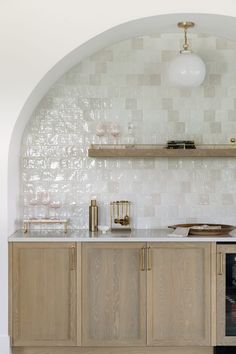 a kitchen with white tile and wooden cabinets, an oven in the corner and shelves on the wall