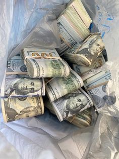 a pile of money sitting on top of a plastic bag