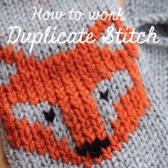 an orange and gray knitted object with the words how to work duplicatestitch