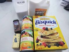 some food is laying out on the table next to milk, butter and yogurt