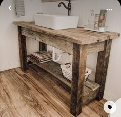 a bathroom with a sink, mirror and towel rack in the middle of the room