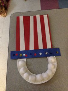 a child's craft made to look like an american flag on top of a toilet