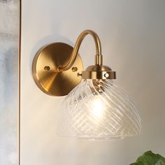 a wall light with a glass shade on it