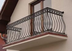 an iron balcony railing on the side of a house