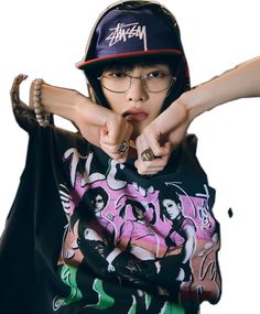 a young boy wearing glasses and a hat pointing his finger at the camera with both hands