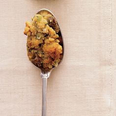 a spoon filled with food sitting on top of a table