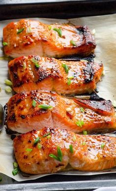 grilled salmon fillets on a baking sheet