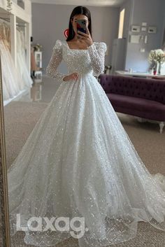 a woman is taking a selfie in her wedding dress while wearing a white gown