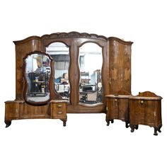 an antique dresser and mirror set with two matching tables in the middle, one is made from wood