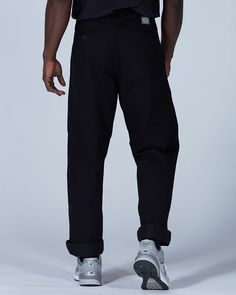 The Takibi Chino Pants are casual fire-resistant pants. The pants are made of cotton and modacrylic. The Takibi Chino Pants feature a button closure, dual side pockets, a coin pocket, and dual back pockets. The Takibi Chino Pants are designed to fit loose in the leg, with the hem hitting below the ankle. We recommend taking your normal size for a standard fit. The model stands 6' and wears size L. Cotton Casual Pants, Fire Grill, Chino Pants, Cotton Pants, Outdoor Accessories, Long Beach, Chinos Pants, Cut And Style, Parachute Pants